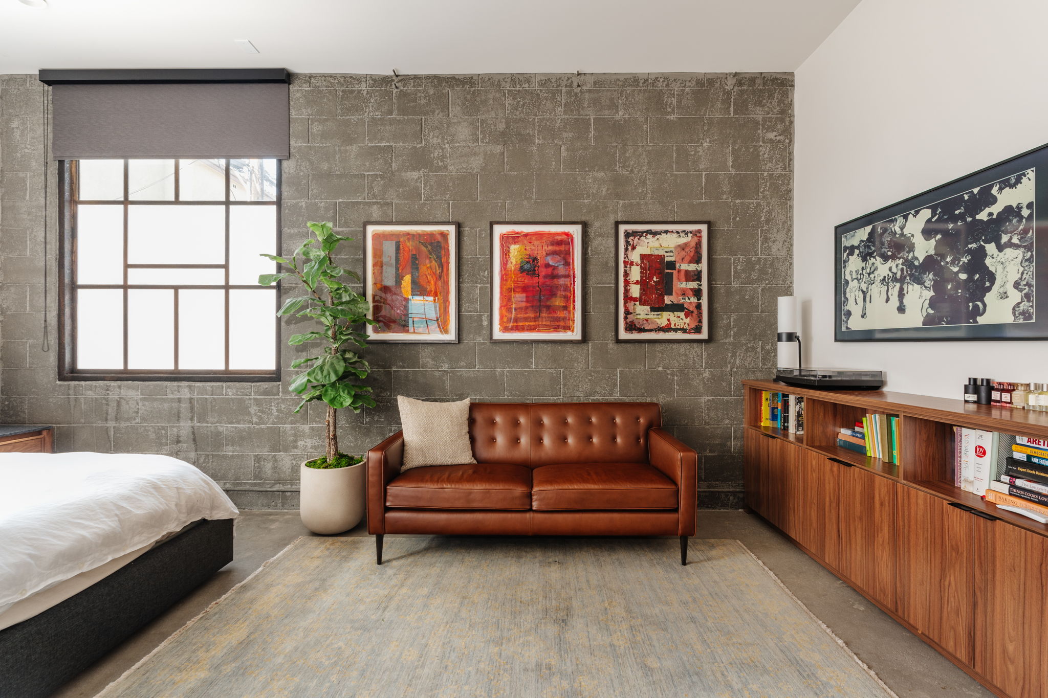 Bedroom lounge wall with three untitled 2004 red abstract artworks and a black and white drawing by Anna Rac